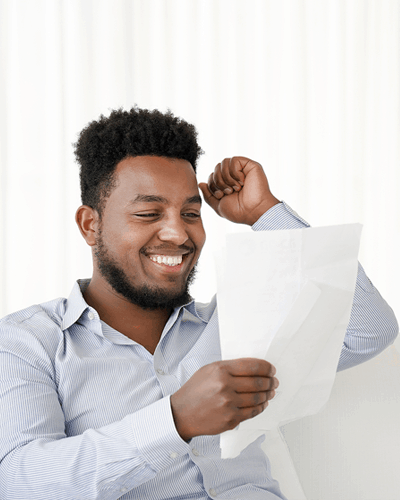 young African American male reading a loan approval letter